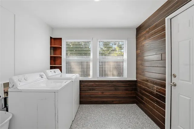 a bathroom with a sink a toilet and next to a window