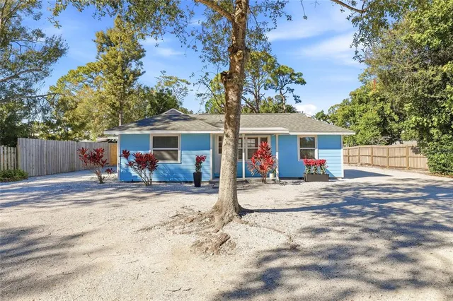 front view of a house with a tree in the background
