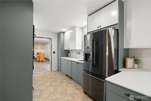 a kitchen with a refrigerator and a sink