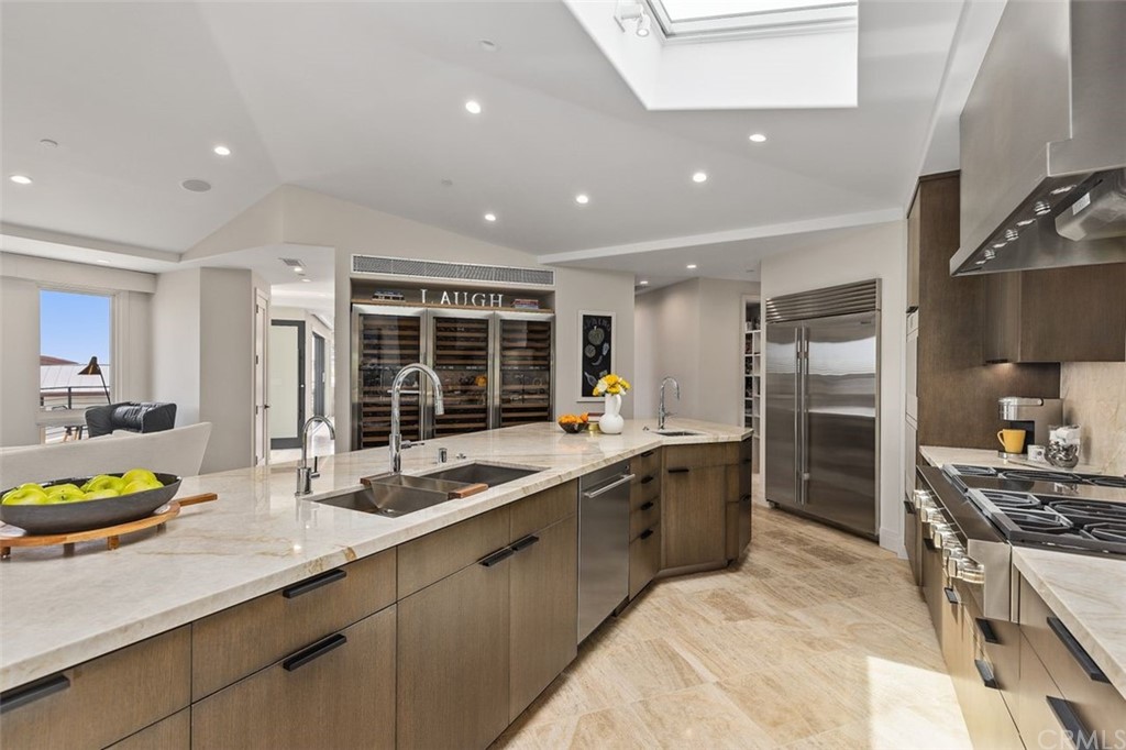 846 Emerald Bay Laguna Beach, CA 92651 - Photo 19 of 42 a large kitchen with a sink and stainless steel appliances