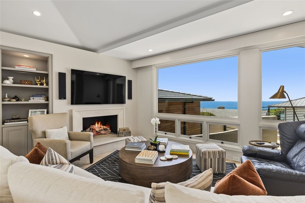 846 Emerald Bay Laguna Beach, CA 92651 - Photo 22 of 42 a living room with furniture and a fireplace