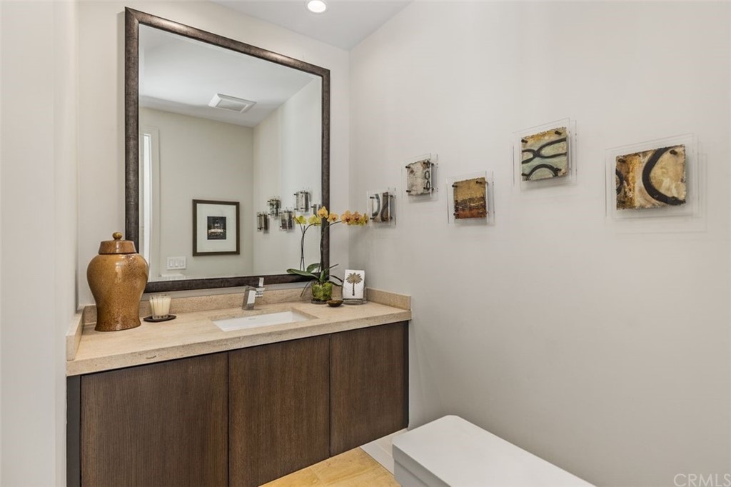 846 Emerald Bay Laguna Beach, CA 92651 - Photo 23 of 42 a bathroom with a granite countertop sink a toilet and mirror
