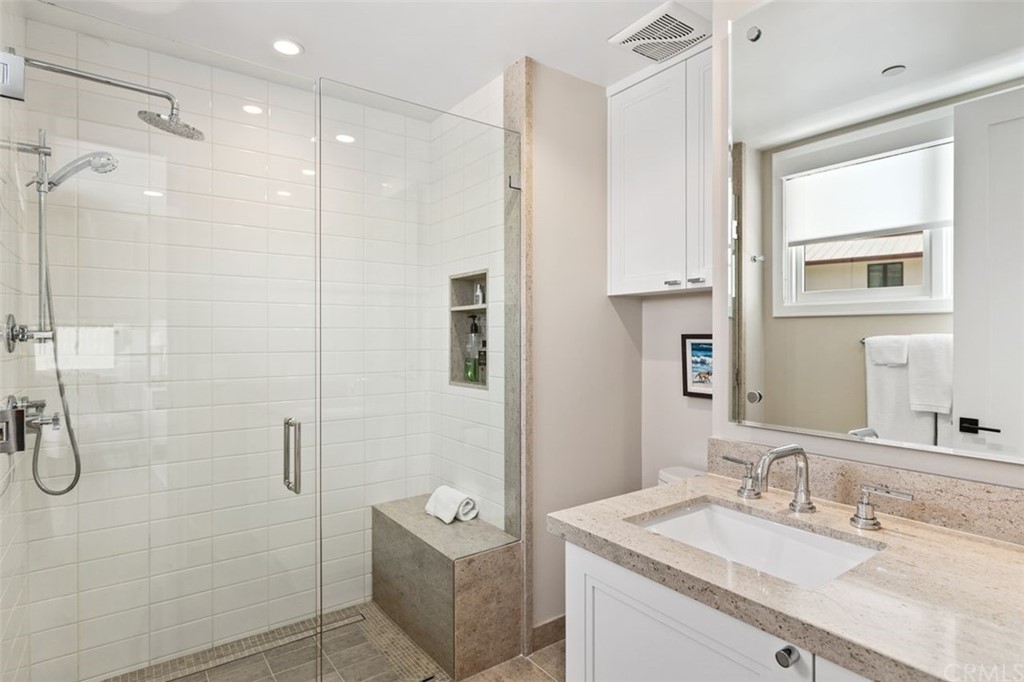 846 Emerald Bay Laguna Beach, CA 92651 - Photo 37 of 42 a bathroom with a granite countertop sink a shower and a mirror