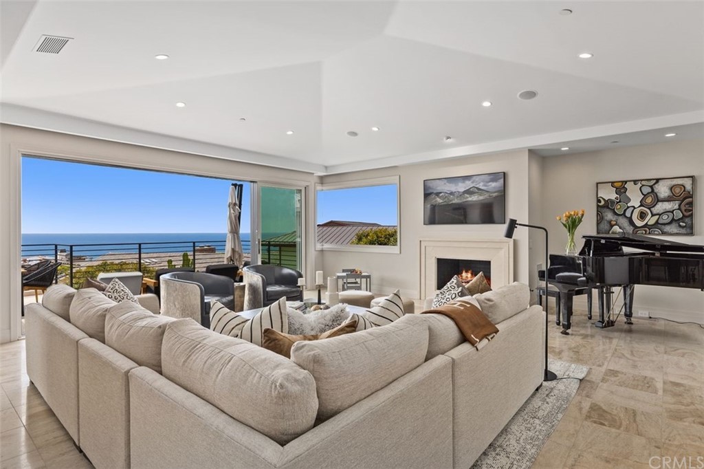 846 Emerald Bay Laguna Beach, CA 92651 - Photo 5 of 42 a living room with furniture fireplace and a table