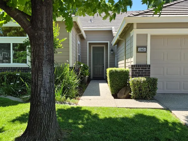 a front view of a house with garden