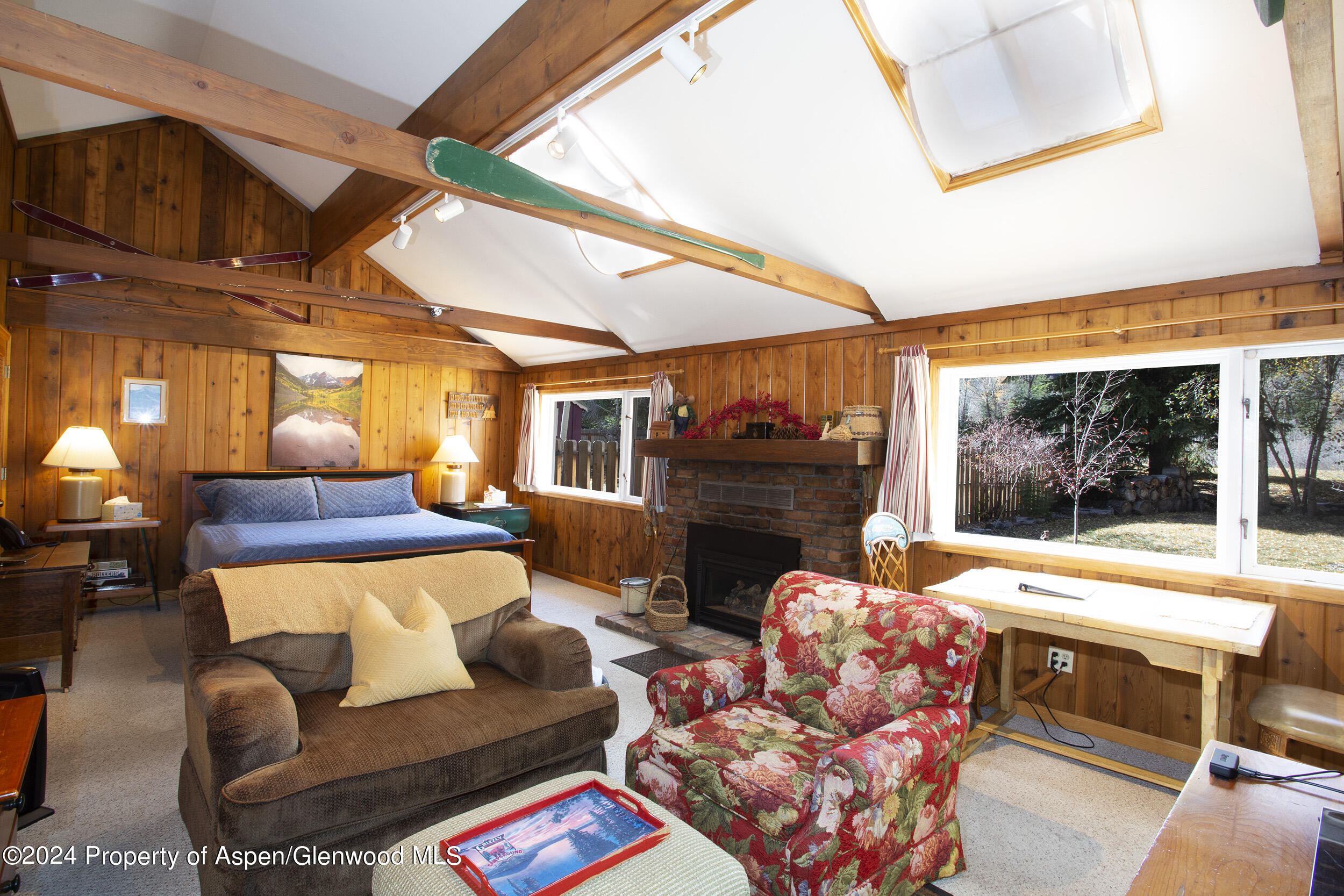 385 Redstone Boulevard Redstone, CO 81623 - Photo 11 of 20 a living room with furniture a fireplace and next to a window
