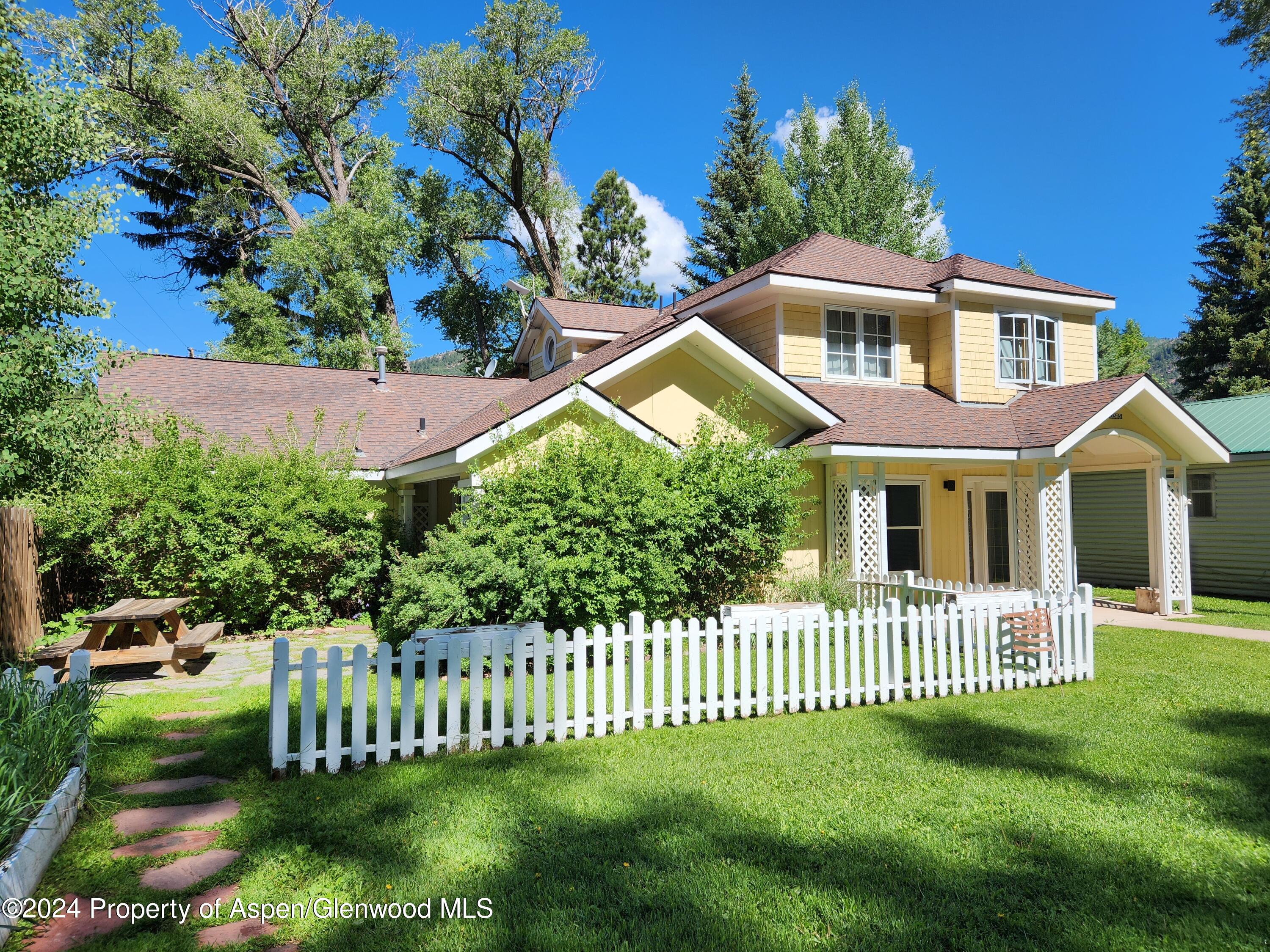 385 Redstone Boulevard Redstone, CO 81623 - Photo 2 of 20 a front view of a house with a garden