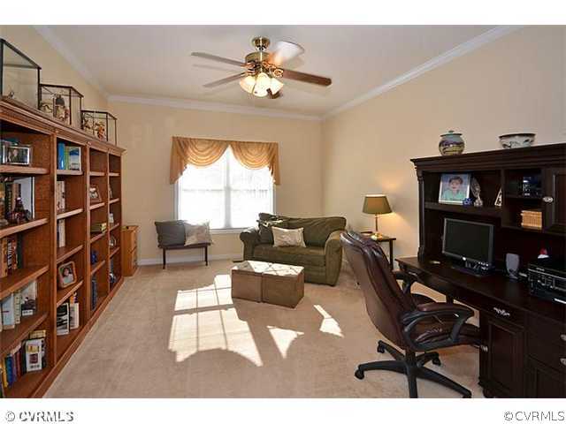 8800 Beaver Bridge Road Moseley, VA 23120 - Photo 10 of 24 a living room with furniture a bookshelf and a window