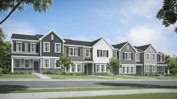 a front view of a residential houses with yard and green space