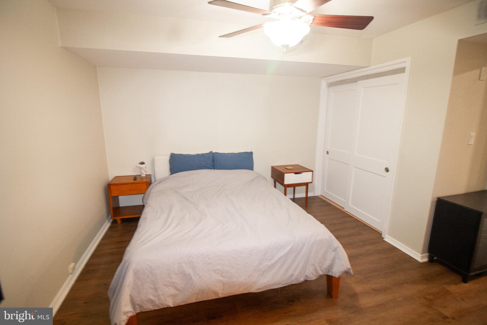 7548 Spring Lake Drive, Unit A Bethesda, MD 20817 - Photo 11 of 23 a bedroom with a bed and a flat screen tv