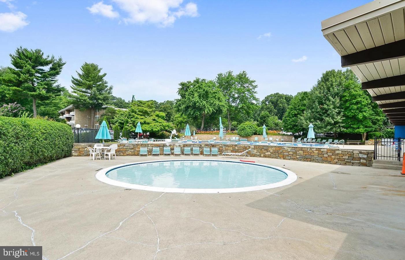 7548 Spring Lake Drive, Unit A Bethesda, MD 20817 - Photo 19 of 23 a swimming pool with outdoor seating and yard