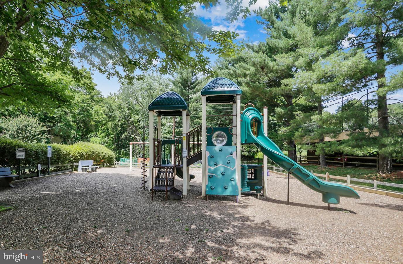 7548 Spring Lake Drive, Unit A Bethesda, MD 20817 - Photo 20 of 23 a view of a house with large trees and sitting area