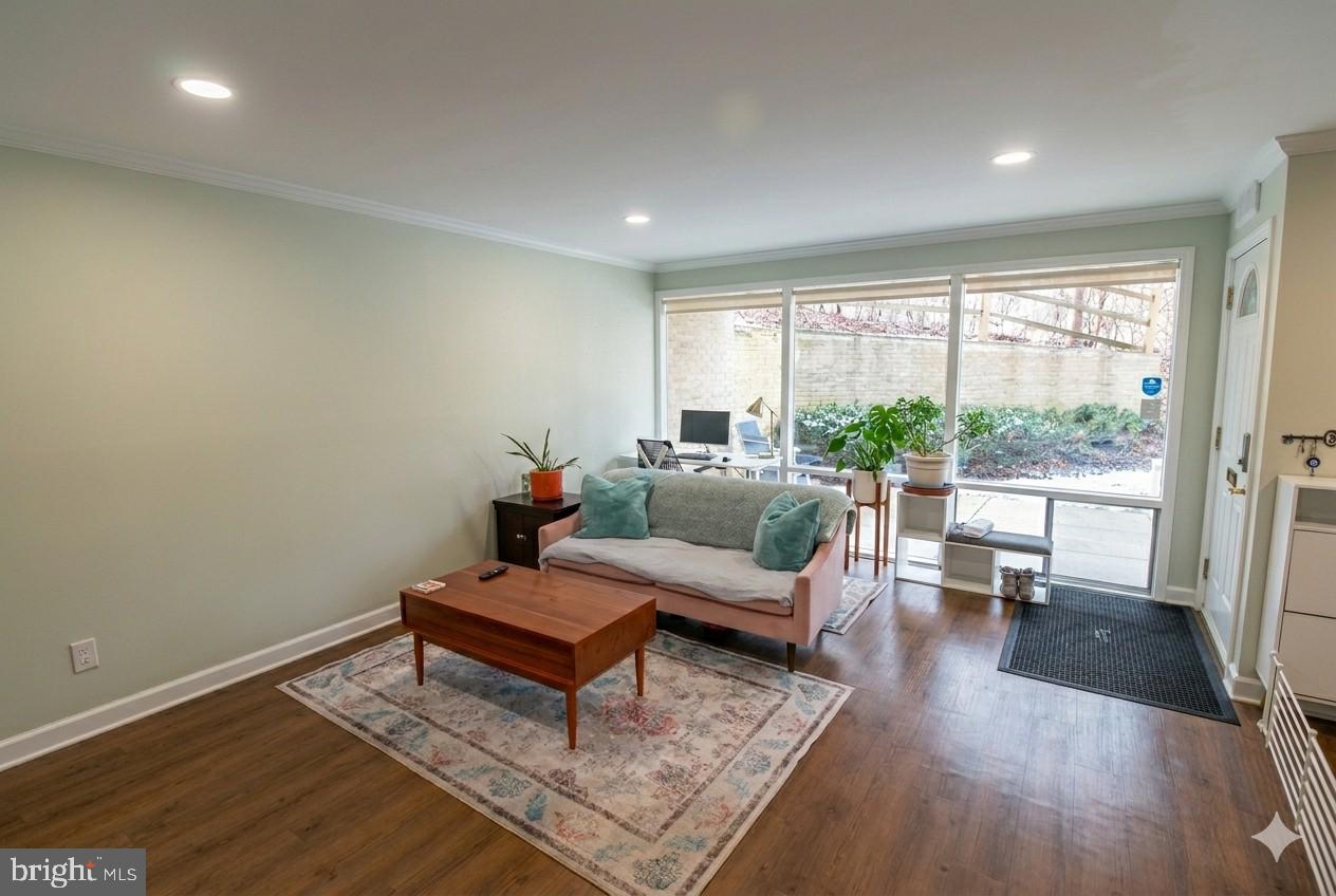 7548 Spring Lake Drive, Unit A Bethesda, MD 20817 - Photo 2 of 23 a living room with furniture and a wooden floor