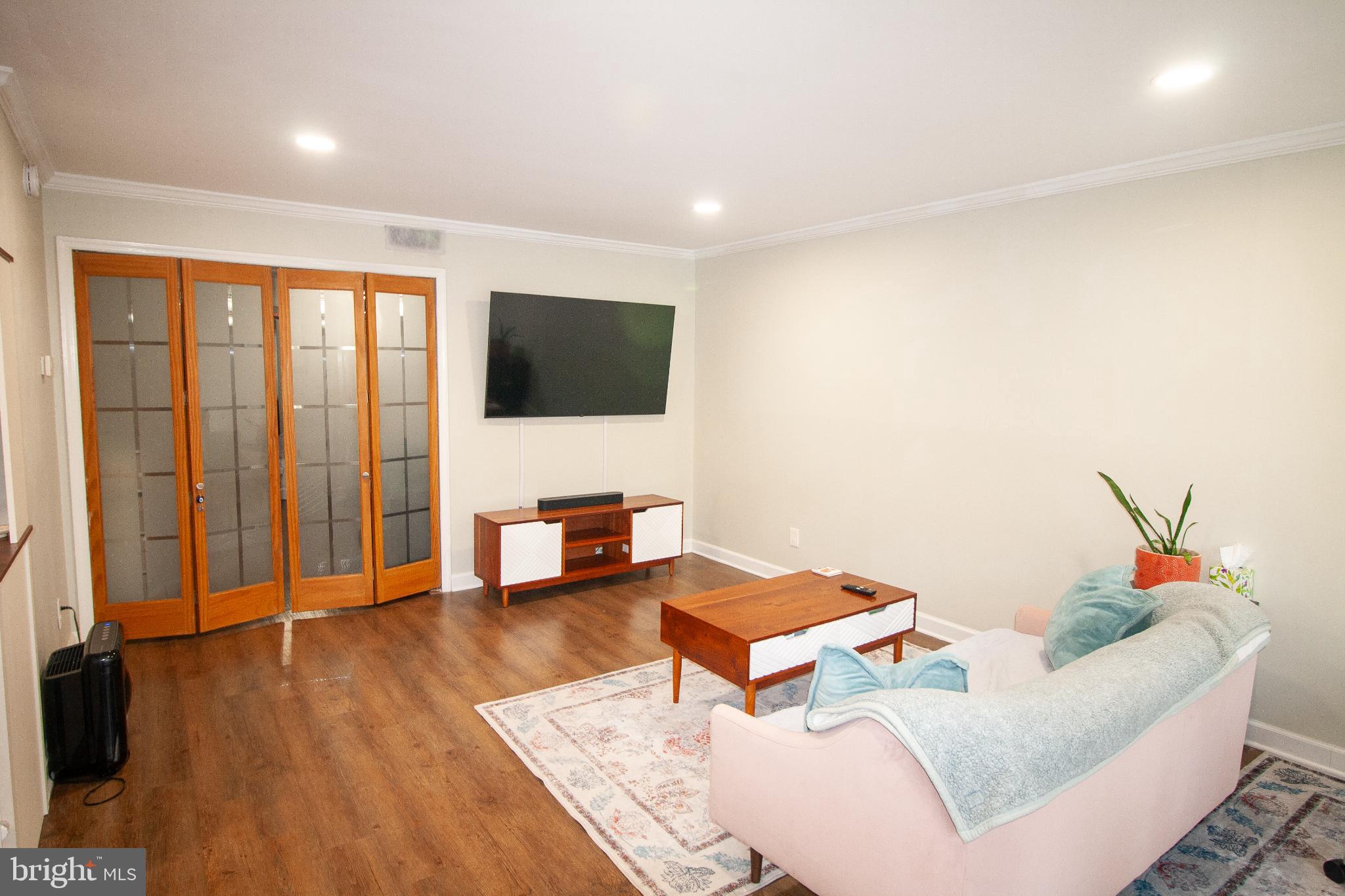7548 Spring Lake Drive, Unit A Bethesda, MD 20817 - Photo 4 of 23 a living room with furniture and a flat screen tv