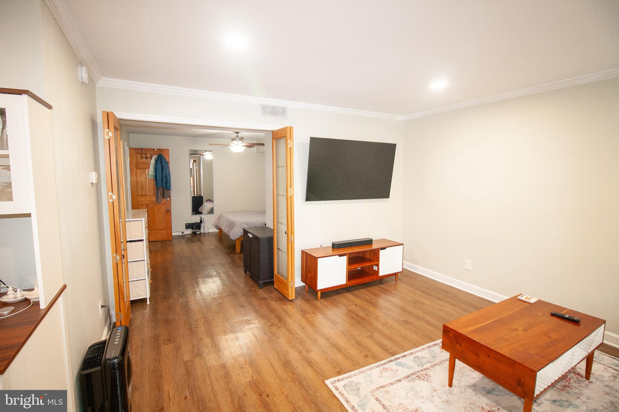 7548 Spring Lake Drive, Unit A Bethesda, MD 20817 - Photo 6 of 23 a living room with furniture and a flat screen tv
