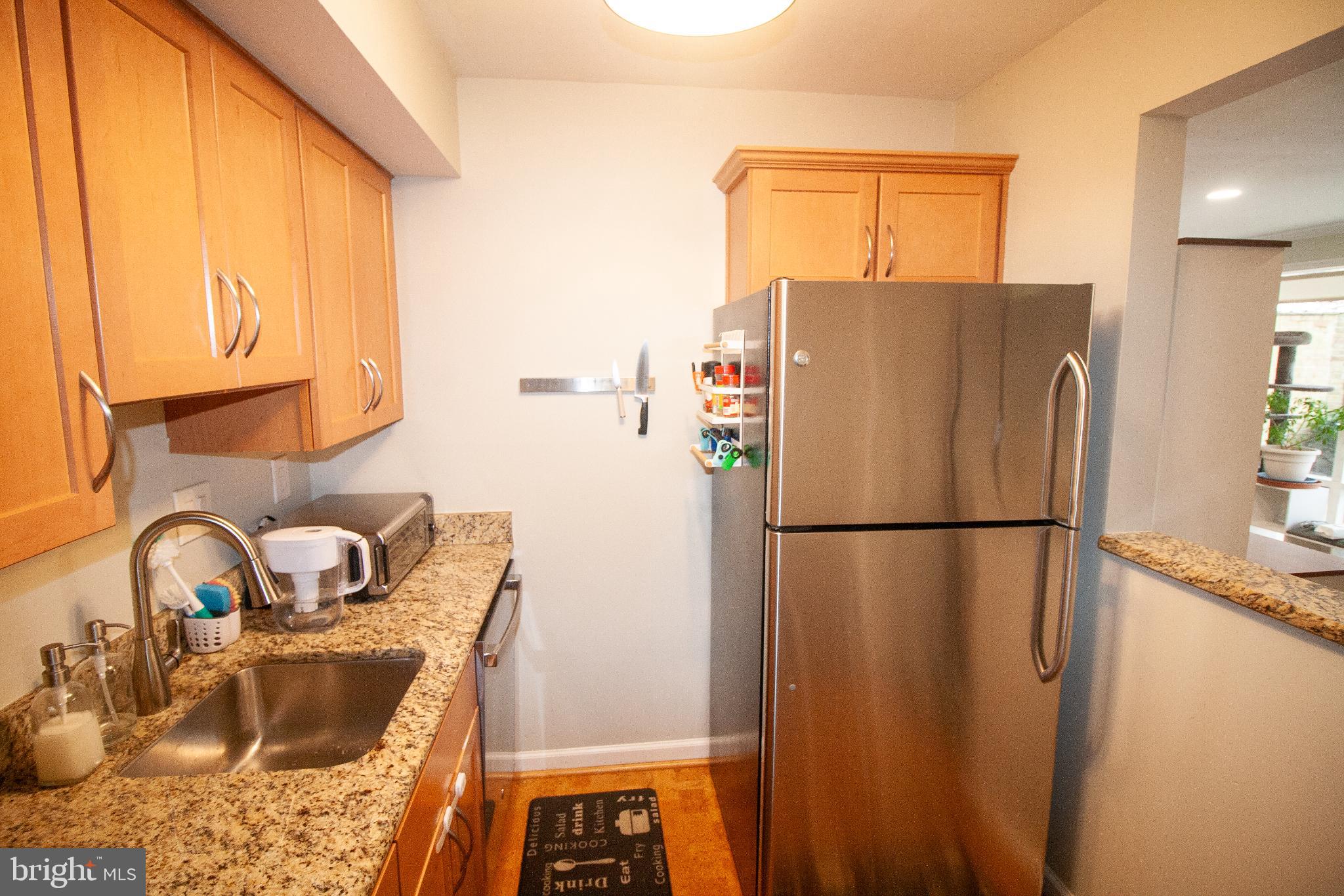 7548 Spring Lake Drive, Unit A Bethesda, MD 20817 - Photo 8 of 23 a white refrigerator freezer sitting inside of a kitchen