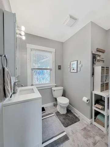 a bathroom with a sink toilet and a mirror
