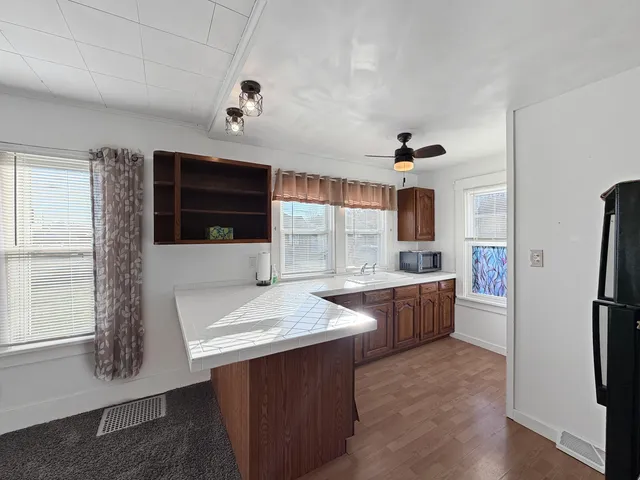 a kitchen with refrigerator and window
