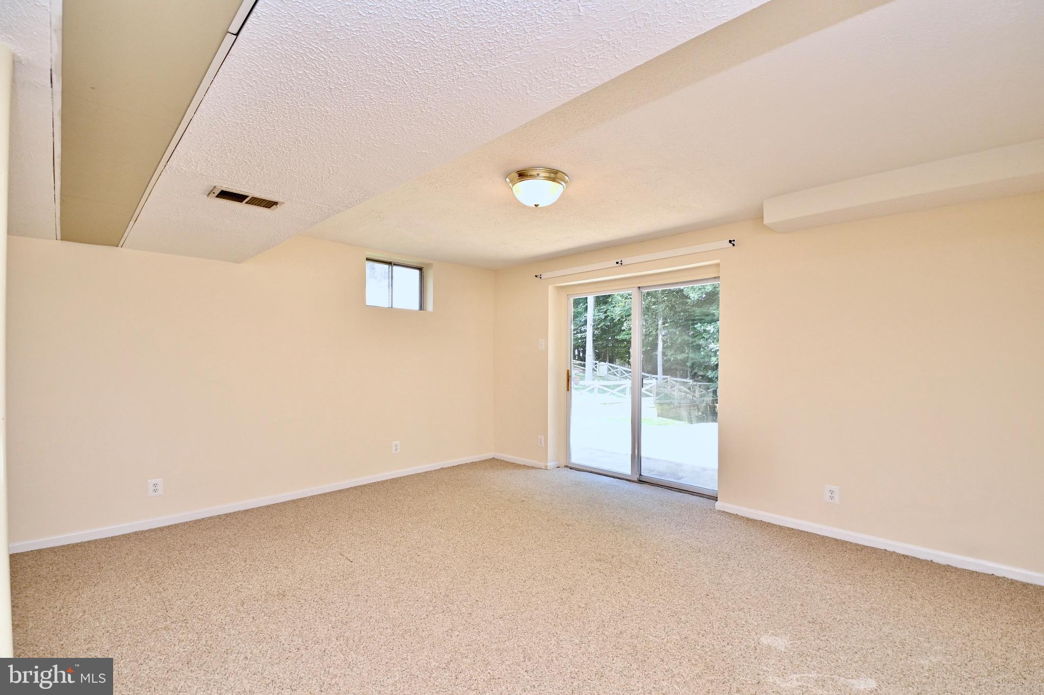 8113 Winter Blue Court Springfield, VA 22153 - Photo 41 of 58 Game area of rec room leads to stone patio