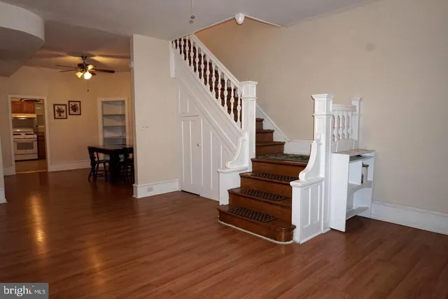 a view of entryway and hall with wooden floor