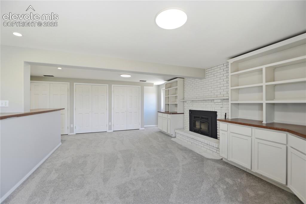 19027 Murphy Road Peyton, CO 80831 - Photo 23 of 48 Carpet, Closets, Built Ins, Fireplace, Dry Bar