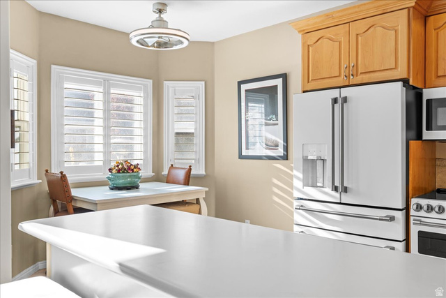 7824 South Sequoia Tree Lane Sandy, UT 84094 - Photo 13 of 43 Kitchen featuring white appliances, light countertops, and hanging light fixtures