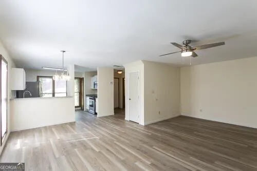 a view of empty room with wooden floor and window