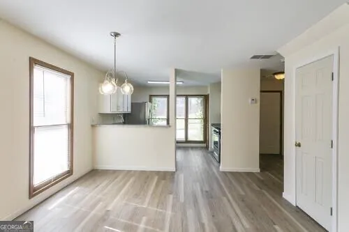 a kitchen with granite countertop a stove top oven a sink a counter space and cabinets