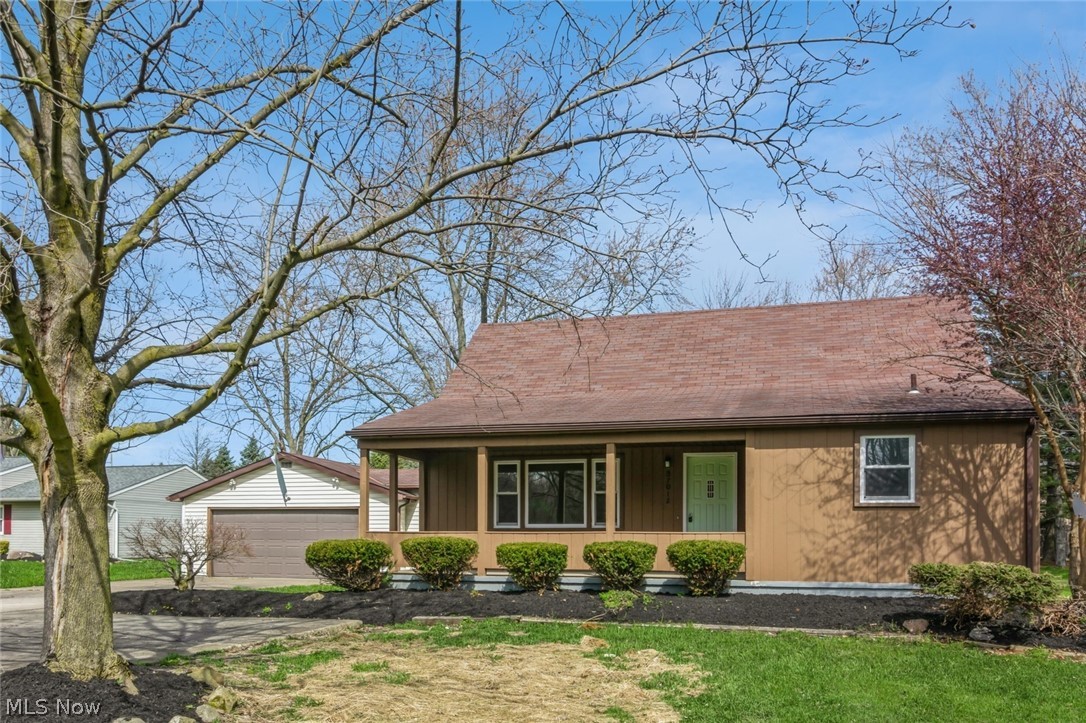37012 Sugar Ridge Road North Ridgeville, OH 44039 - Photo 2 of 26 View of front of home featuring covered porch, an outdoor structure, and a garage