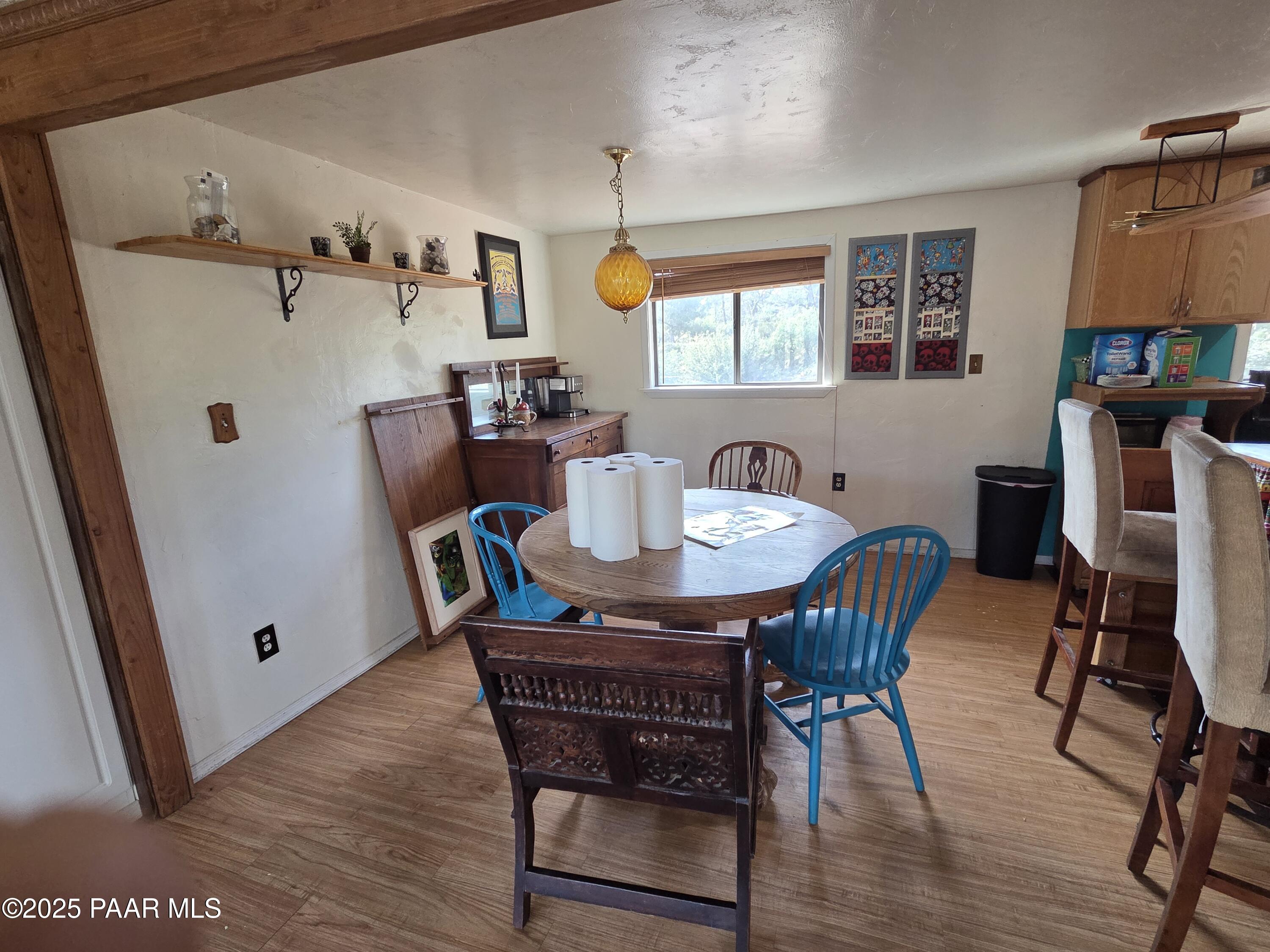 7250 West Hootenanny Road Prescott, AZ 86305 - Photo 16 of 30 a view of a dining room with furniture and wooden floor