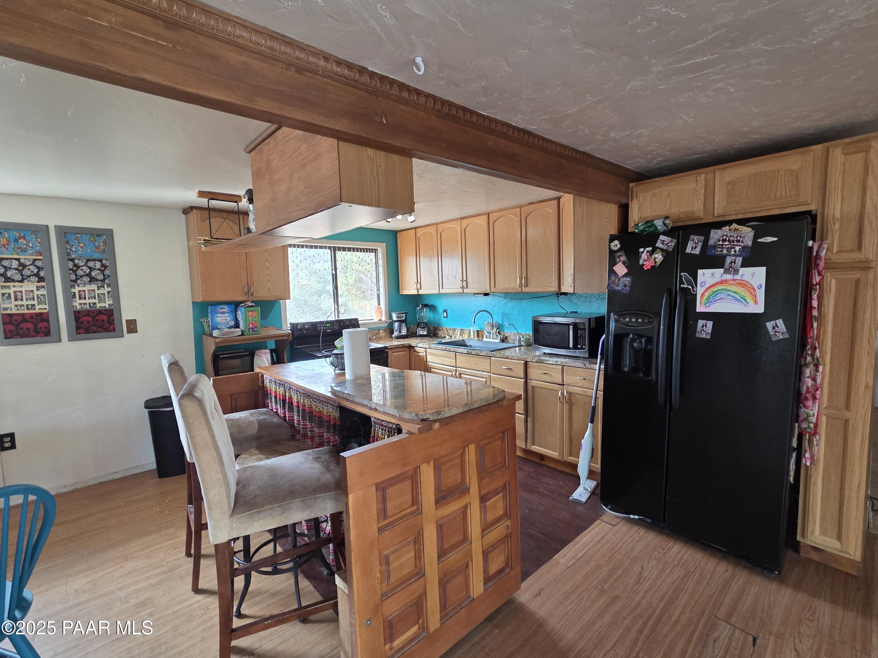 7250 West Hootenanny Road Prescott, AZ 86305 - Photo 17 of 30 a kitchen with stainless steel appliances granite countertop a refrigerator a sink a stove and island