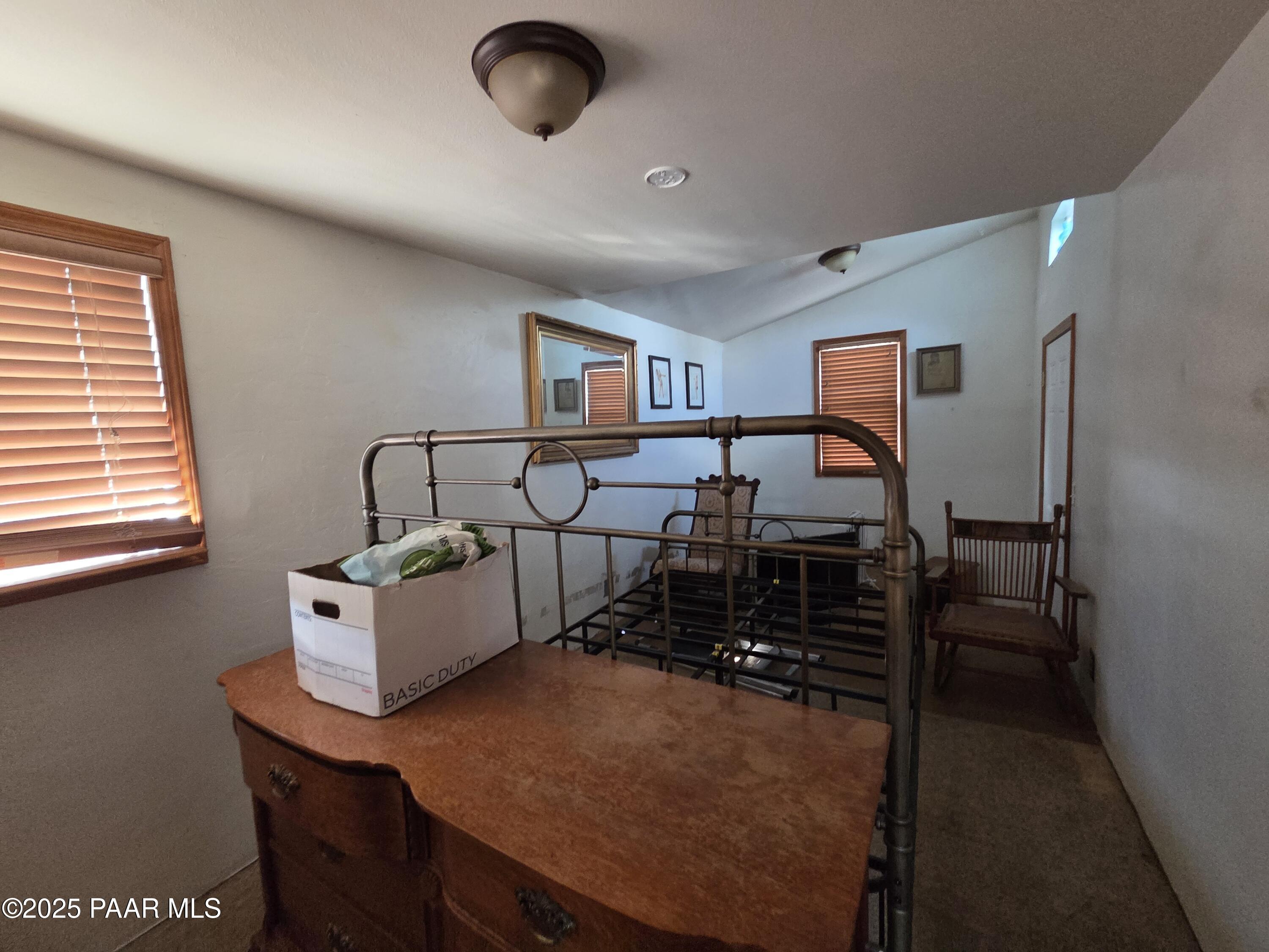 7250 West Hootenanny Road Prescott, AZ 86305 - Photo 23 of 30 a bed room with furniture and a window