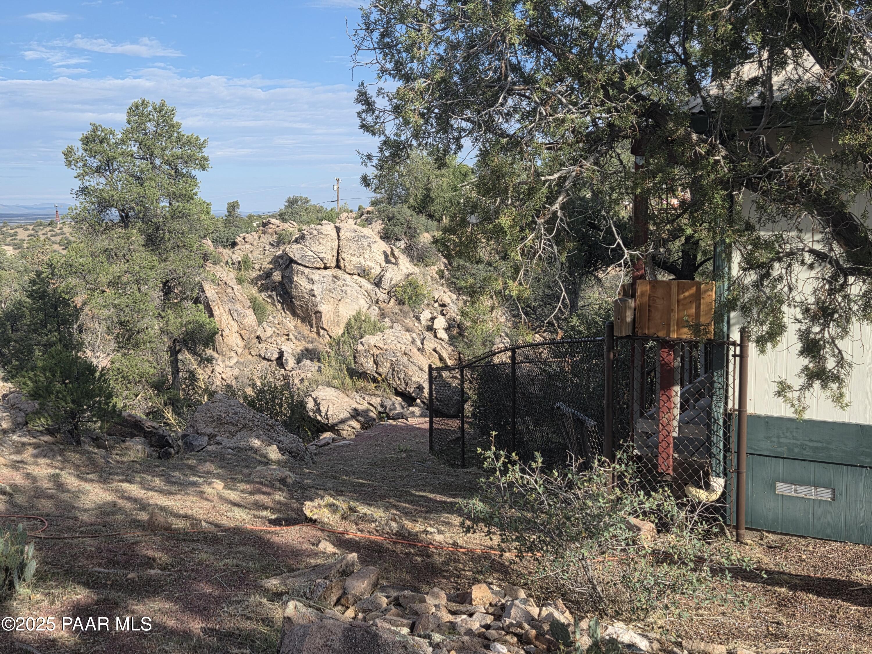 7250 West Hootenanny Road Prescott, AZ 86305 - Photo 5 of 30 a backyard of a house with lots of green space
