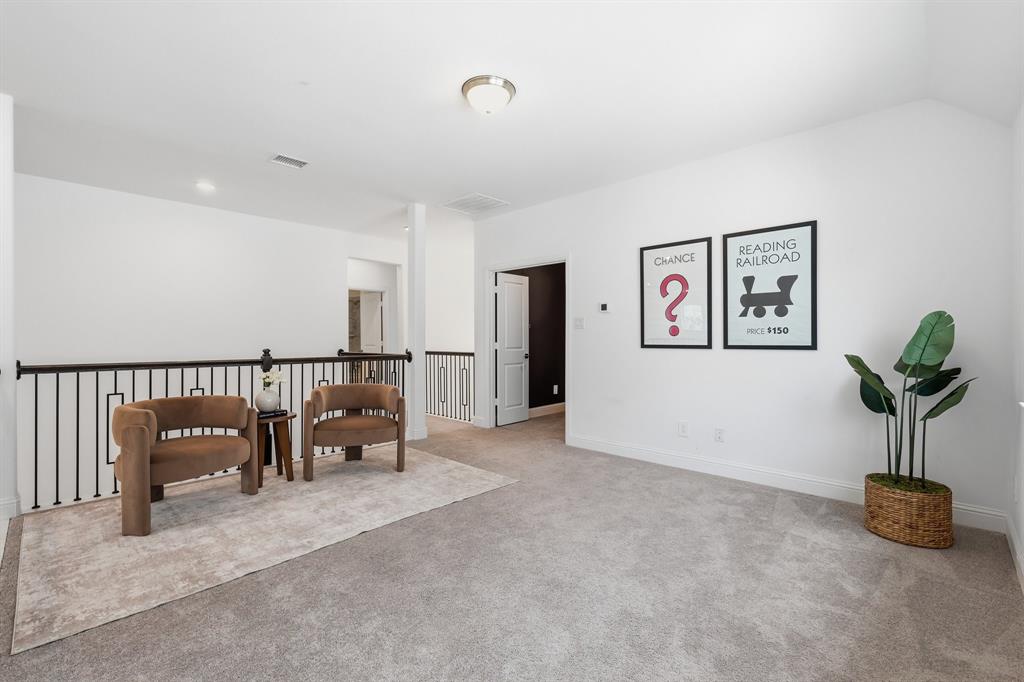 539 Farrell Lane Allen, TX 75013 - Photo 18 of 39 Carpeted loft area featuring white walls, recessed lighting, and a black wrought iron railing overlooking the space below