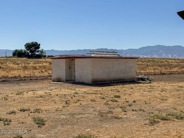 a view of a snow with a mountain in the background