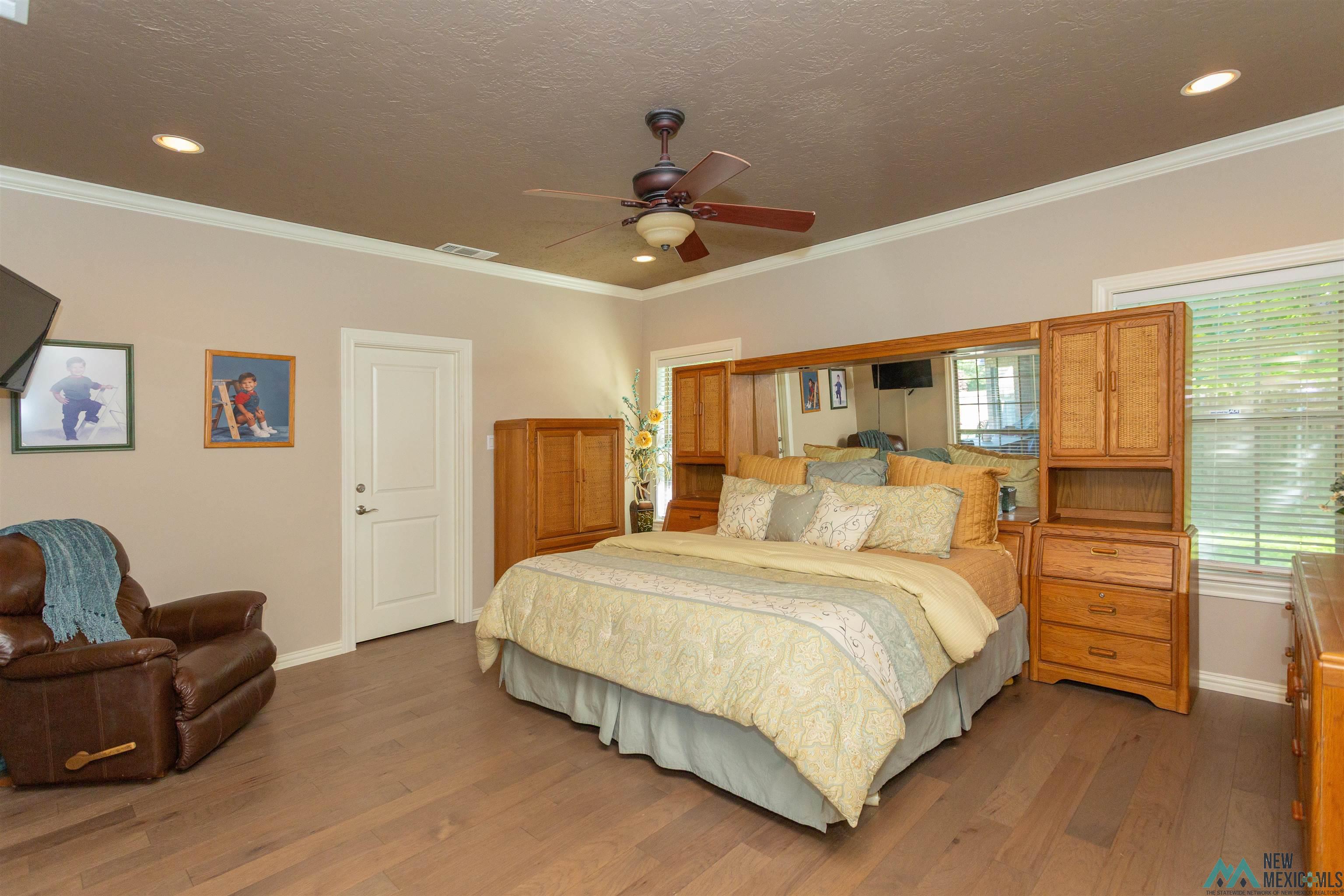 3103 Onate Road Roswell, NM 88201 - Photo 27 of 57 Bedroom with ornamental molding, wood finished floors, a ceiling fan, recessed lighting, and a textured ceiling