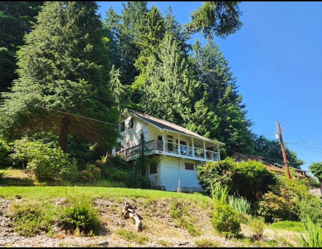 14745 Southwest Spring Beach Road Vashon, WA 98070 - Photo 1 of 6 a view of a house with a yard