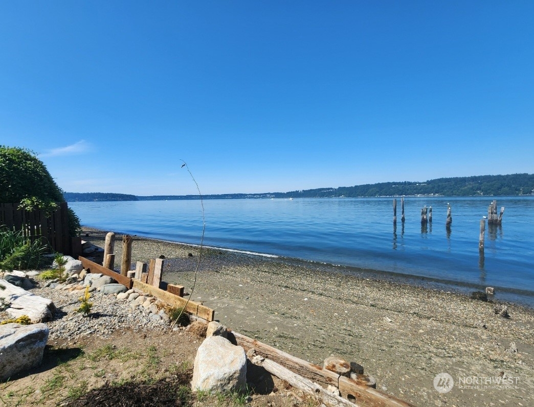14745 Southwest Spring Beach Road Vashon, WA 98070 - Photo 3 of 6 a view of a backyard with wooden fence