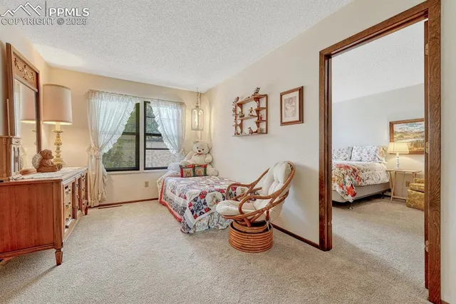 a bedroom with furniture and a large window