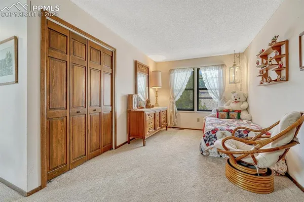 a bedroom with furniture and a window