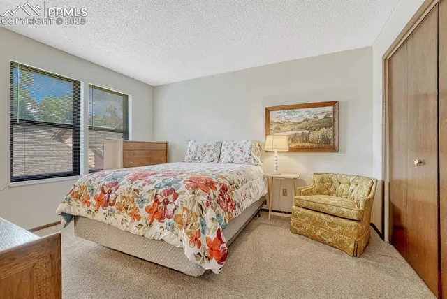 a bedroom with a bed rug and window