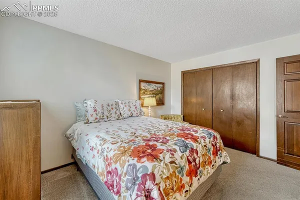 a bedroom with a large bed and a closet
