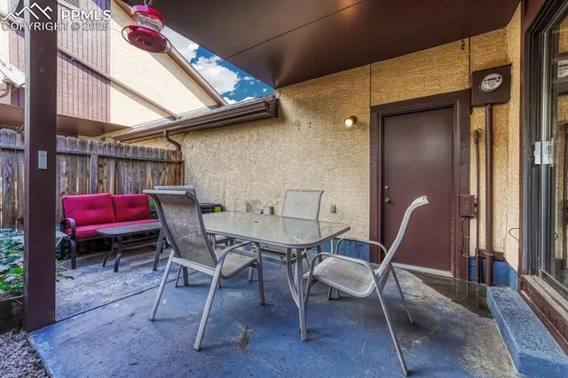 a patio with a table and chairs