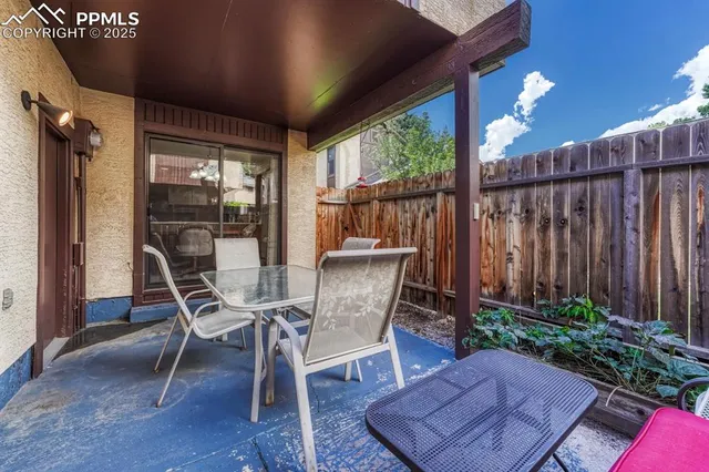 a view of a porch with chairs and backyard