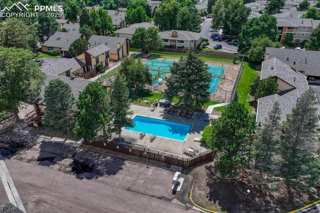 an aerial view of a house with yard swimming pool and outdoor seating