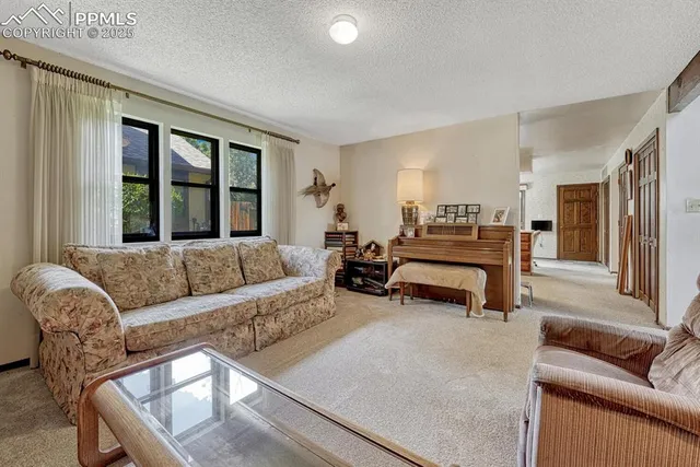 a living room with furniture and large windows