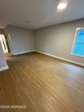 an empty room with wooden floor
