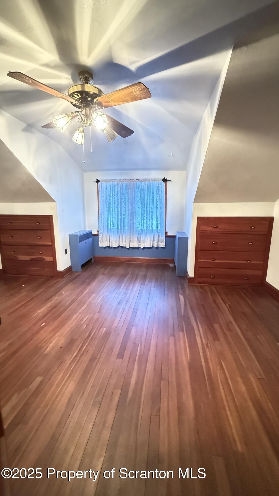 220 Hickory Ridge Road Carbondale, PA 18407 - Photo 37 of 51 a view of an empty room with wooden floor and a ceiling fan