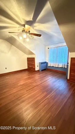 a view of a room with wooden floor and a window