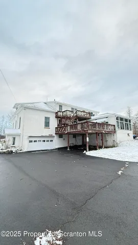 a view of an empty room with a fireplace and large windows